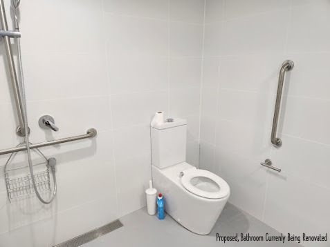 Accessible bathroom at Clontarf House - grab rails, level access shower, purpose-built for disability